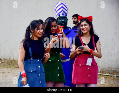 Mumbai, India. 23rd Dec, 2018. Cosplayers are seen busy on mobile phone during the second day of the 8th 'Mumbai Comic Con 2018' at Bombay Exhibition Center in Mumbai. Credit: Azhar Khan/SOPA Images/ZUMA Wire/Alamy Live News Stock Photo