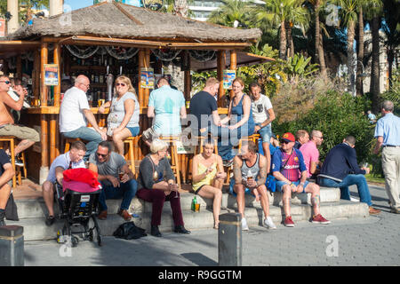 Benidorm, Costa Blanca, Spain, 24th December 2018. British holidaymakers escaping from the cold weather back home flood this popular resort during the Christmas holidays. Drinkers enjoy the hot temps and calm weather at the famous Tiki Beach Bar on Levante beach today in Benidorm on the Costa Blanca coast. Temperatures were in the mid to high 20's Celsius today in this Mediterranean hotspot. Credit: Mick Flynn/Alamy Live News Stock Photo