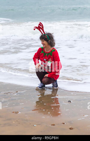Sexy woman dressed as Santa's helper in a red bikini top and Santa's ...