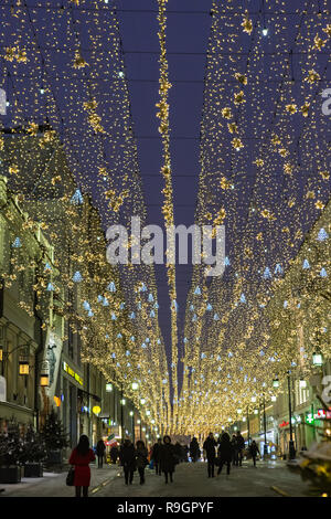 Moscow, the Russian Federation - December 24, 2018:  Muscovites walking on streets of the downtown decorated and illuminated for Christmas and New Year's holidays. Credit: Sergey Podkolzin/Alamy Live News Stock Photo