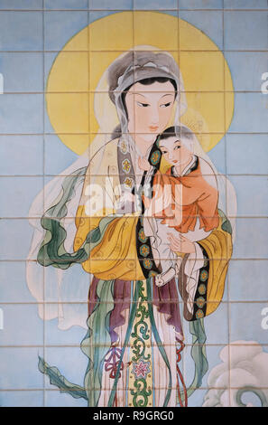 A mosaic painting depicting Mary and the infant Jesus donated by the Catholic community of China in style that boldly reflect the culture of the country and visualize the annunciation in its own local eyes hanging on the wall around the front courtyard of the Roman Catholic Church of the Annunciation or the Basilica of the Annunciation in the city of Nazareth in Galilee northern Israel. Stock Photo