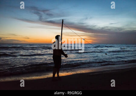 Uruguay: Uruguay, La Floresta, small city and resort on the Costa de Oro (Golden Coast). At dusk, whole families are fishing in the waves, with nets a Stock Photo