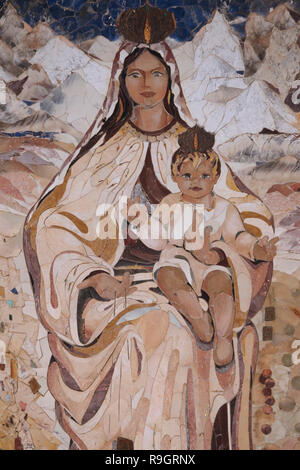 A mosaic painting depicting Mary and the infant Jesus donated by the Catholic community of Chile in style that boldly reflect the culture of the country and visualize the annunciation in its own local eyes hanging on the wall around the front courtyard of the Roman Catholic Church of the Annunciation or the Basilica of the Annunciation in the city of Nazareth in Galilee northern Israel. Stock Photo