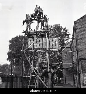 1968, south London boys boarding school, England, schoolboys playing on a wooden climbing frame or structure, outside their school building, a large urban victorian, inner-city house,, England, UK. Stock Photo