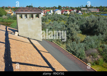 Roofing construction. Asphalt shingles installing on house construction roof with all details. Stock Photo