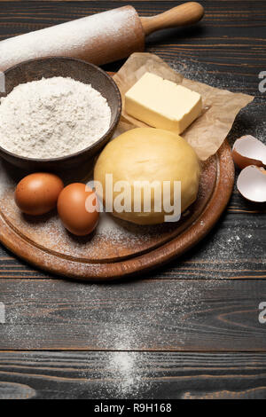 unrolled and unbaked Shortcrust pastry dough recipe on wooden background Stock Photo