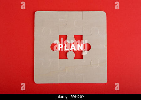 Business Teamwork Concept - Jigsaw Puzzle Pieces with word "Plan" on red background Stock Photo