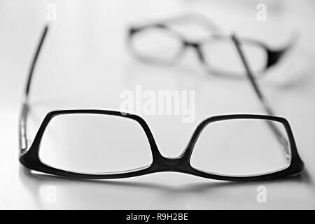 glasses on display on a table at an optician shop stock photo Stock Photo