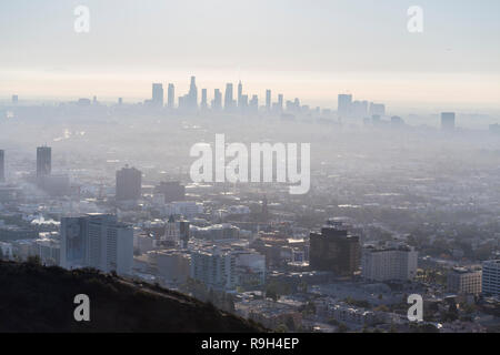 Los Angeles, California, USA - December 16, 2018:  Foggy morning cityscape view of Hollywood and downtown LA from hilltop. Stock Photo