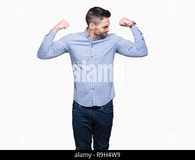 Young handsome man over isolated background showing arms muscles smiling proud. Fitness concept. Stock Photo