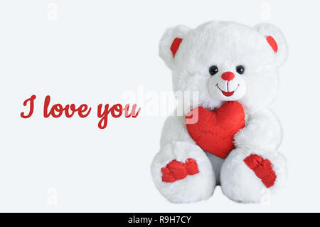 Valentine. Bear polar bear with a heart in his hands. Inscription I love you. Stock Photo