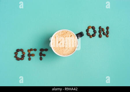 Coffee lay flat on turquoise background with words 'on off 'concept image. Stock Photo