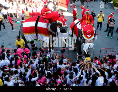 Ayutthaya, Thailand. 24th Dec, 2018. Elephants dressed in a Santa Claus costume performs for students during Christmas celebrations at Jirasart school in Ayutthaya province, north of Bangkok, Thailand on December 24, 2018. Credit: Chaiwat Subprasom/Pacific Press/Alamy Live News Stock Photo