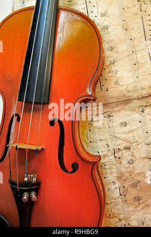 1937 old violin on the background of notes Stock Photo