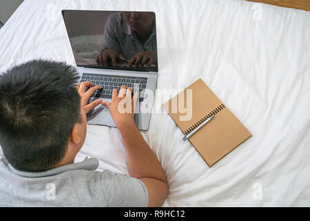 Overhead view of young man working on laptop Stock Photo