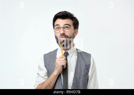 man is thinking about something with pencil Stock Photo