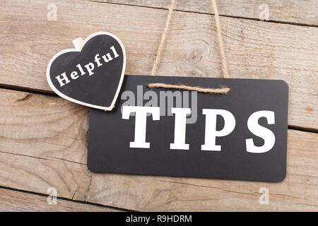 Blackboards with inscription "Helpful TIPS" on wooden background Stock Photo