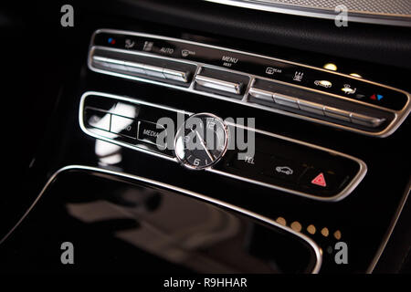 Luxury car interior details. Middle console with air and multimedia controls. Stock Photo