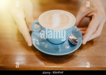 Close-up of unrecognizable man preparing coffee in blue cup with pitcher Stock Photo