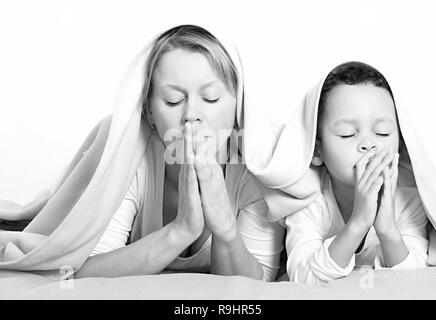 Mother and child praying together stock image and stock photo Stock Photo