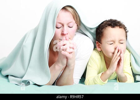 Mother and child praying together stock image and stock photo Stock Photo