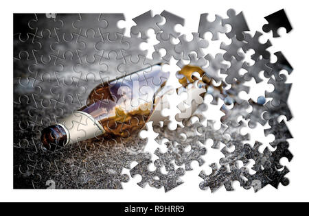 Puzzle of a broken bottle of beer resting on the ground - Free themselves from alcohol addiction - concept image - Toned image Stock Photo