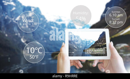 Augmented Reality information technology displayed tablet in mountain - Weather Stock Photo