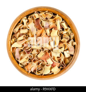 Dried lemon grass in wooden bowl. Sliced stems of lemongrass or oil grass, Cymbopogon citratus, with fragrant leaves, used in cooking and for teas. Stock Photo