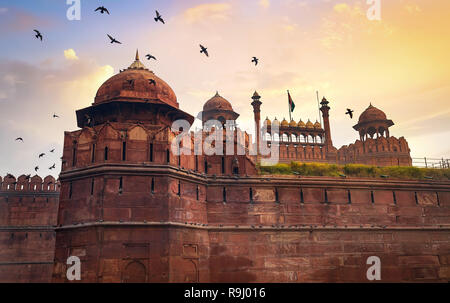 Red Fort Delhi historic monument at sunrise with flying pigeons. Stock Photo