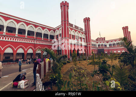 Old Delhi city railway station exterior view with commuters at sunrise. Stock Photo