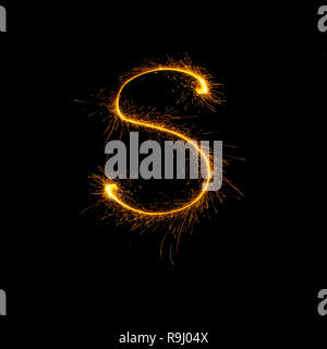 Alphabet sparklers osolated on black background. hristmas single letter Stock Photo