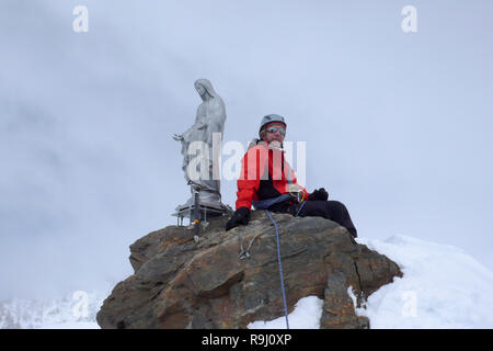 backcountry skier and mountain climber on the summit of Corno Nero in the Alps of Italy on a winter day Stock Photo