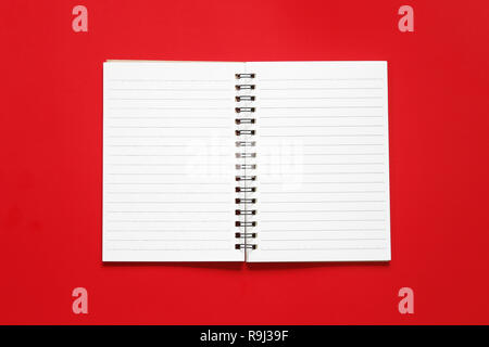 Blank notebook paper on a red art paper background for design in Christmas concept. Stock Photo