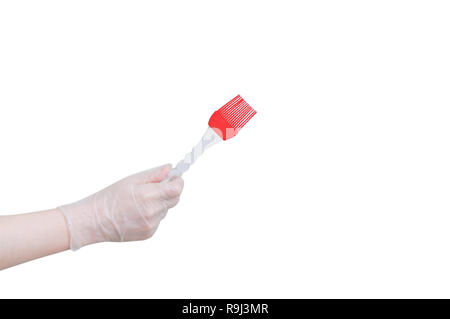 Silicone brush for smearing baking in your hand. Close-up. White isolate Stock Photo