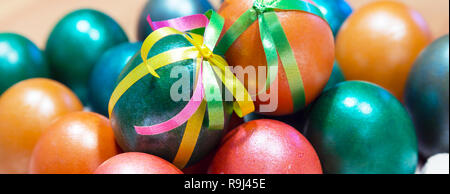 Brightly colored bow decorated easter eggs holiday panoramic banner background Stock Photo
