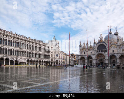VENICE, ITALY, NOV 1st 2018: Saint Mark's or San Marco Square and Cathedral or Palace Domes. Ancient renaissance italian or venetian architecture exterior view. Vivid color. Flood time. People