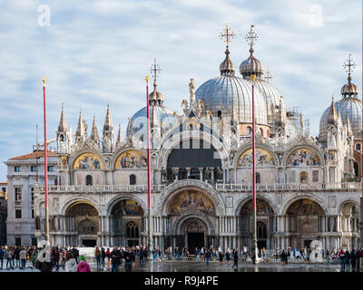 VENICE, ITALY, NOV 1st 2018: Saint Mark's or San Marco Cathedral or Basilica Domes and Bell Tower. Ancient renaissance italian or venetian architecture. Vivid color. People Stock Photo