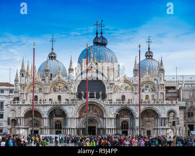 VENICE, ITALY, NOV 1st 2018: Saint Mark's or San Marco Cathedral or Basilica Domes and Bell Tower. Ancient renaissance italian or venetian architecture. Vivid color. People