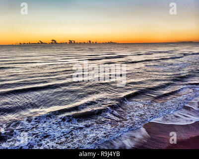 Sunset aerial view of the  on the sea in the golden hour and clouds parade on the horizon Stock Photo