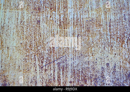 Old metal shield is painted gray paint with rust and cracks. Stock Photo