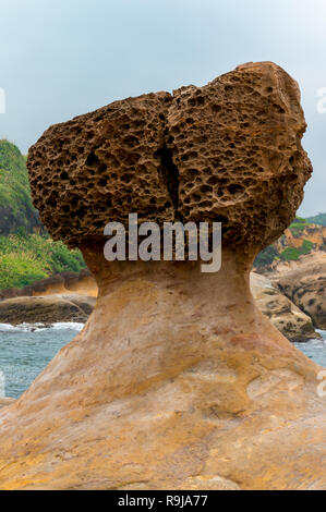 Unique geological formations at Yehliu Geopark in Taiwan on a sunny day with a blue sky with some clouds Stock Photo