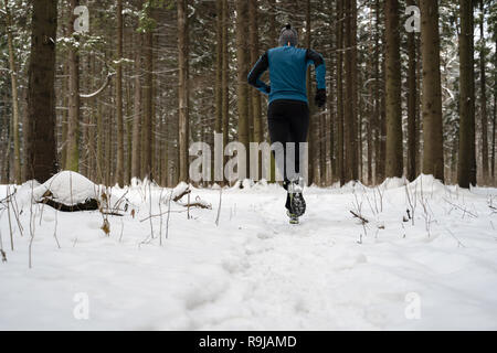 Man in Winter Sports Outfit Running on Snow in a Park Stock Photo - Image  of single, jogging: 216077330