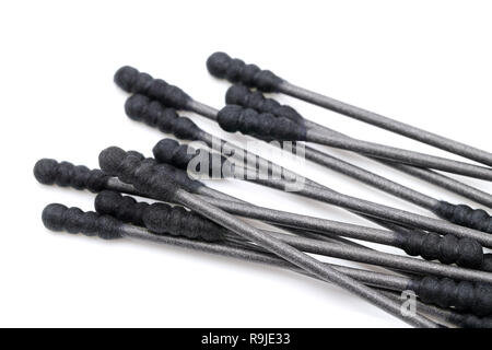 Black cotton swabs with the finger on the white background Stock Photo