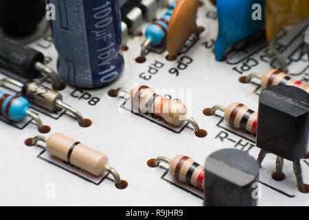 Resistor, Capacitor and Transistor on Circuit Board close up. electronic hardware Stock Photo