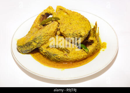 Traditional spicy Indian fish cuisine prepared with tasty Hilsa fish in mustard gravy with green chili. Stock Photo