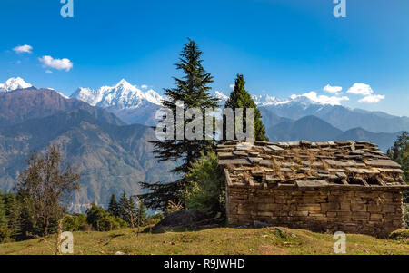 Beautiful landscape view with stone house overlooking the Panchchuli Himalaya range at Munsiyari Uttarakhand India. Stock Photo