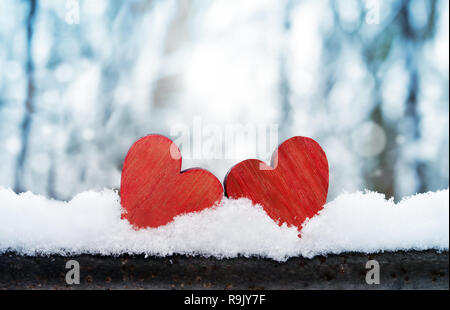 Two beautiful romantic vintage red hearts together on a white snow winter background. Love and St. Valentines Day concept Stock Photo