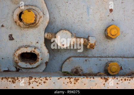Old rusty screws on a neglected panel Stock Photo