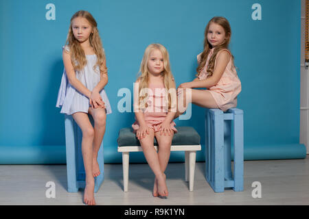 three fashionable little girls blonde girlfriends sister portrait Stock
