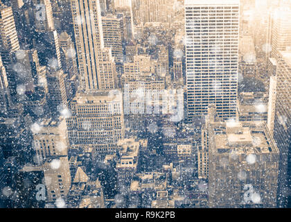 New York City Manhattan skyscraper buildings with snowflakes falling during winter snow storm Stock Photo